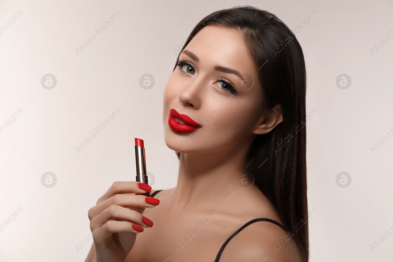 Photo of Beautiful woman with red lipstick on light background