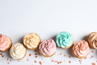 Photo of Flat lay composition with delicious birthday cupcakes and space for text on white background