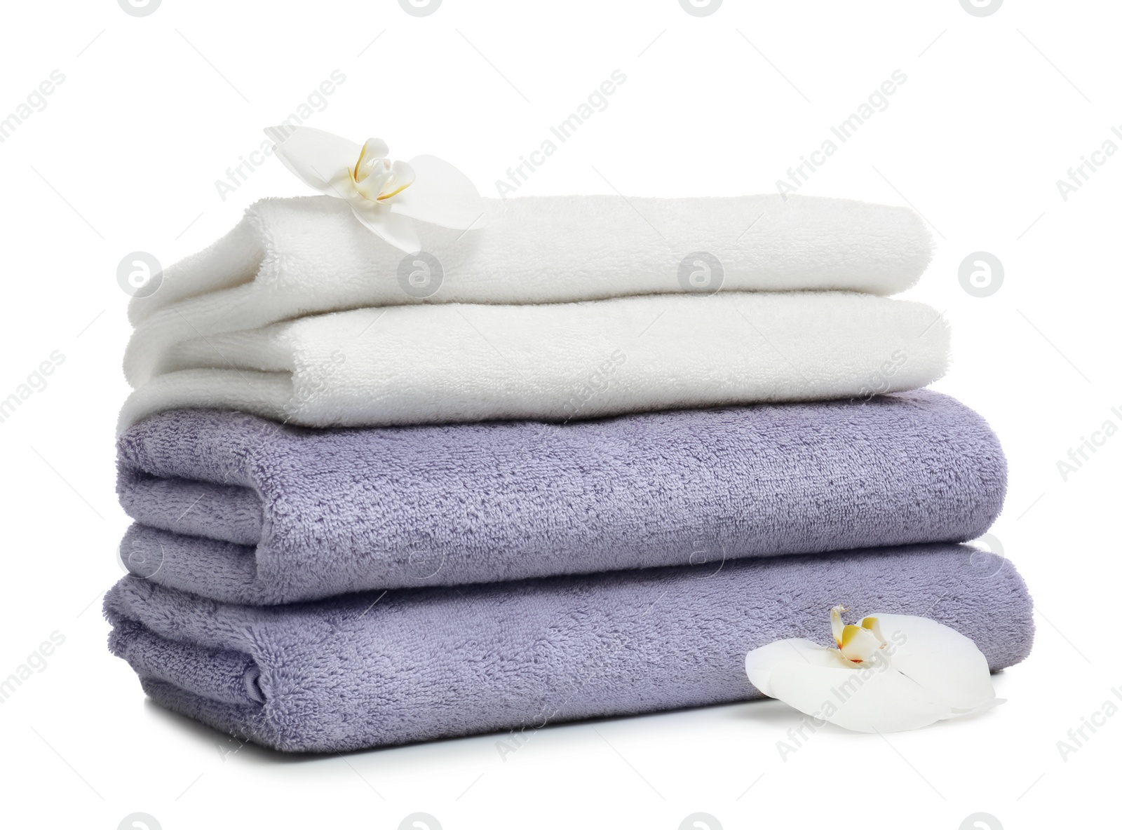 Photo of Stack of clean folded towels with flowers on white background