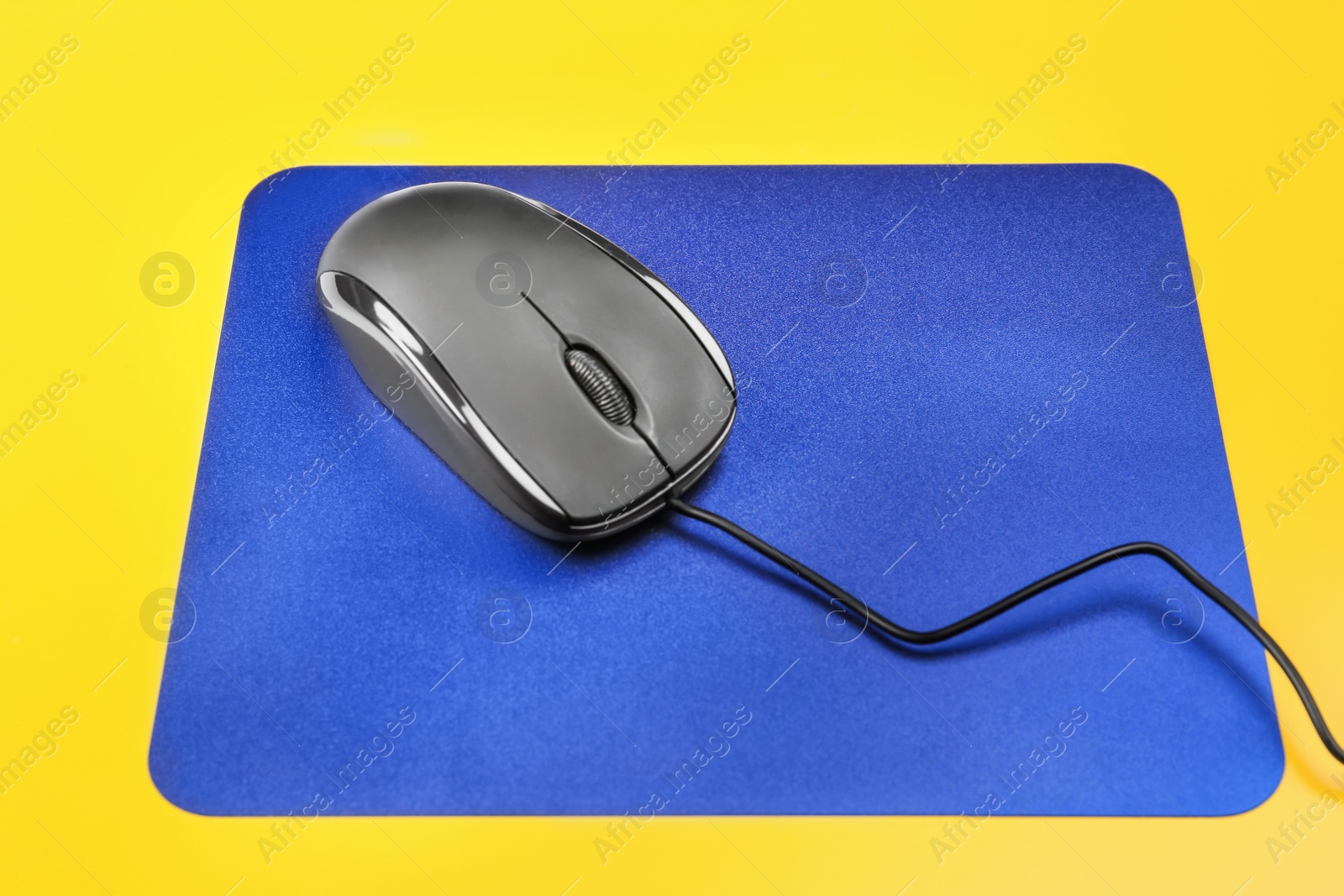 Photo of Blank pad and modern computer mouse on color background