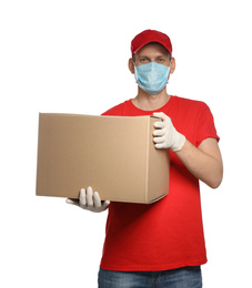 Courier in protective mask and gloves holding cardboard box on white background. Delivery service during coronavirus quarantine