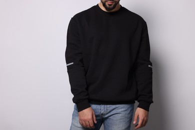 Photo of Man in stylish sweater on white background, closeup