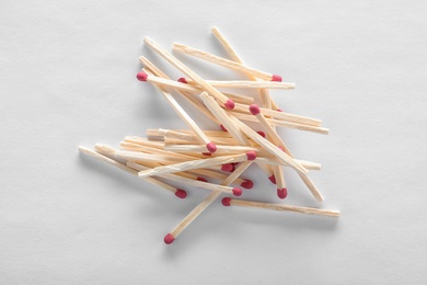 Pile of wooden matches on white background, top view