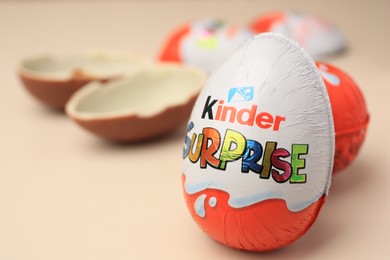 Slynchev Bryag, Bulgaria - May 25, 2023: Kinder Surprise Eggs on beige background, closeup. Space for text