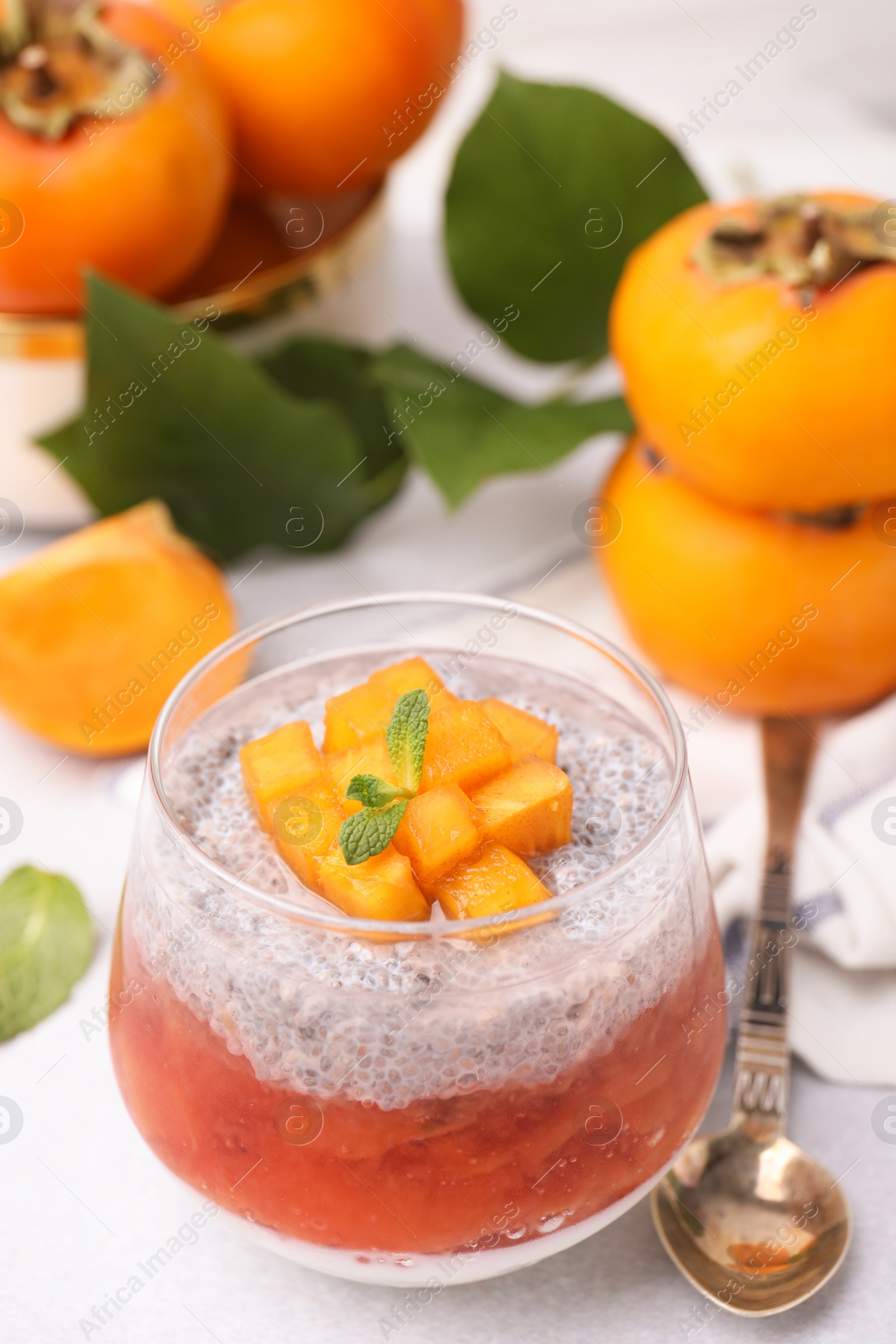 Photo of Delicious dessert with persimmon and chia seeds on table