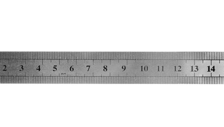 Photo of Metal ruler with measuring length markings in centimeters isolated on white, top view
