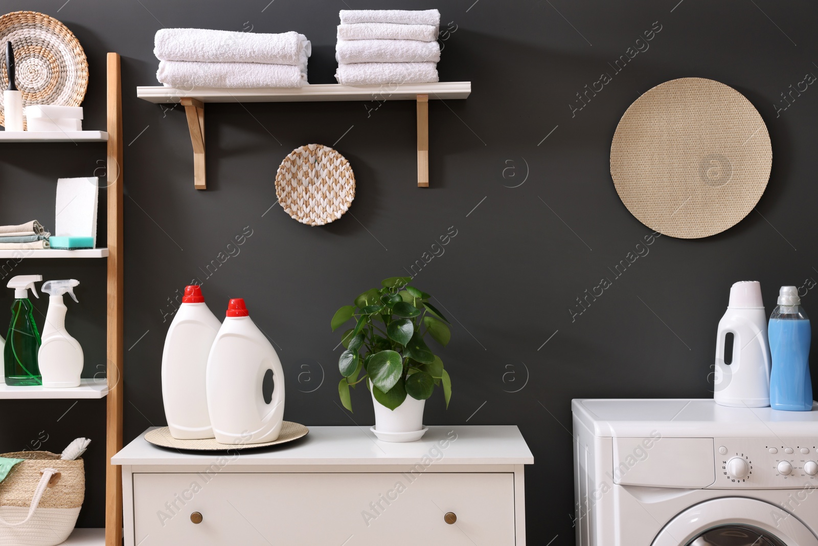 Photo of Laundry room interior with washing machine and furniture