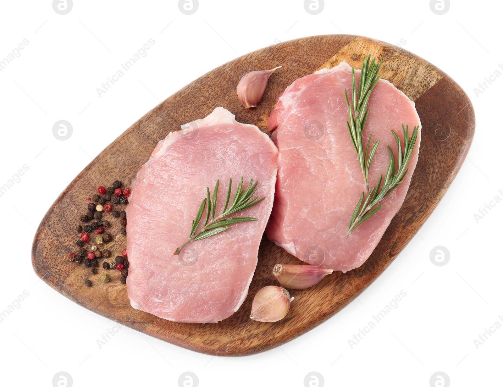 Photo of Wooden board with pieces of raw pork meat and spices isolated on white, top view