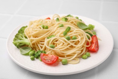 Plate of delicious pasta primavera on white table, closeup