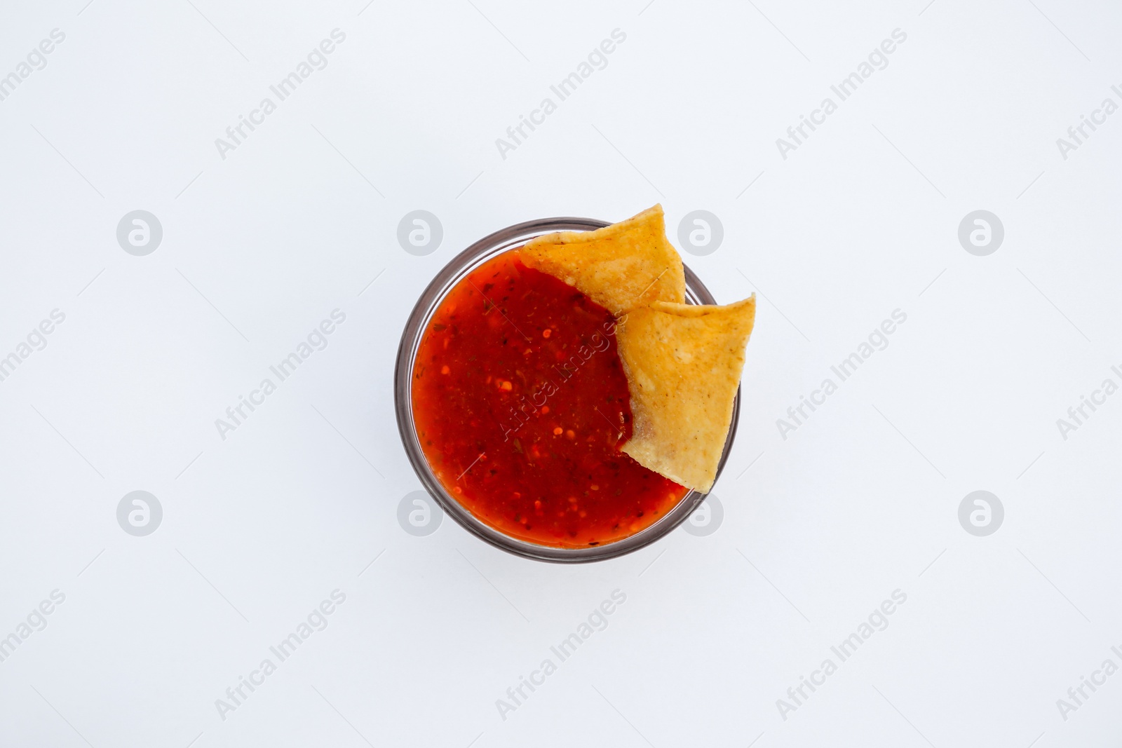 Photo of Tasty salsa sauce and tortilla chips on white background, top view