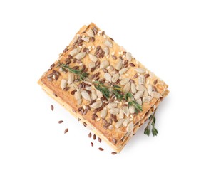 Photo of Stack of cereal crackers with flax, sunflower, sesame seeds and thyme isolated on white, top view