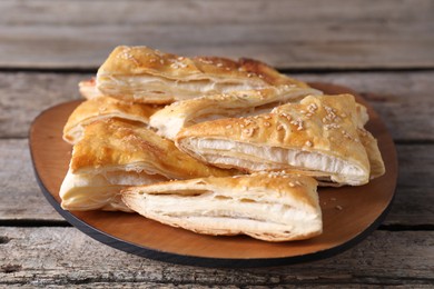 Delicious puff pastry on wooden table, closeup