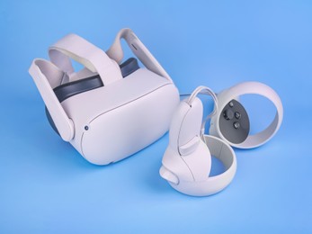 Modern virtual reality headset and controllers on light blue background