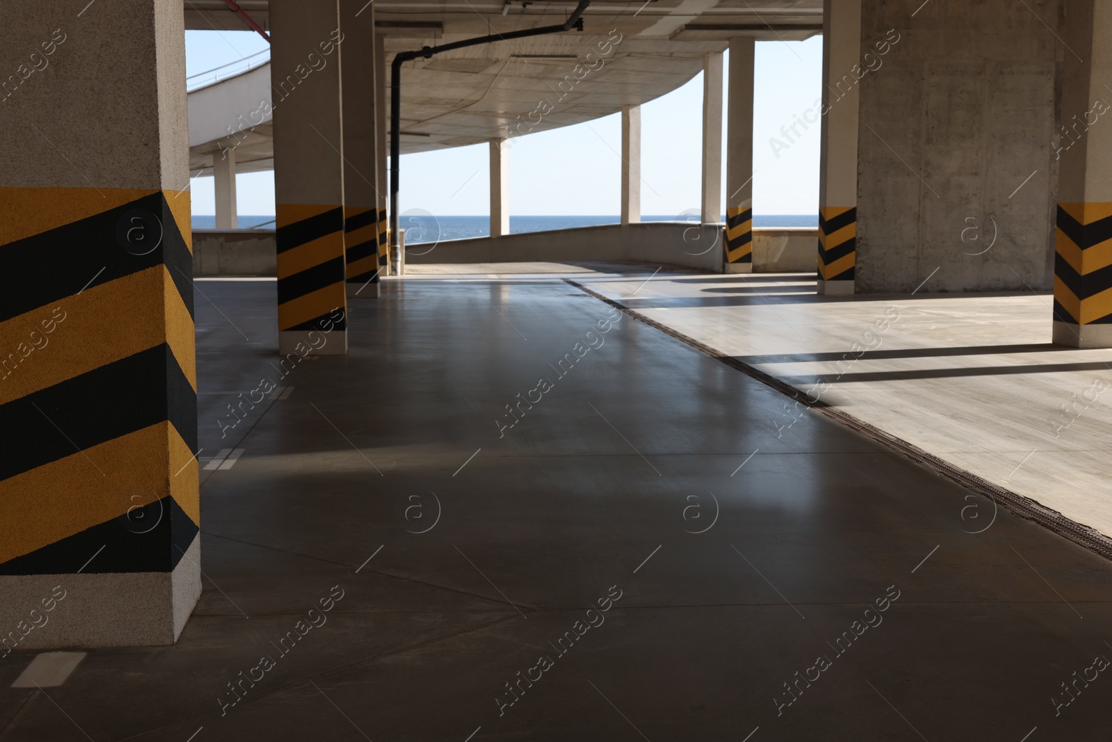 Photo of Empty open car parking garage on sunny day