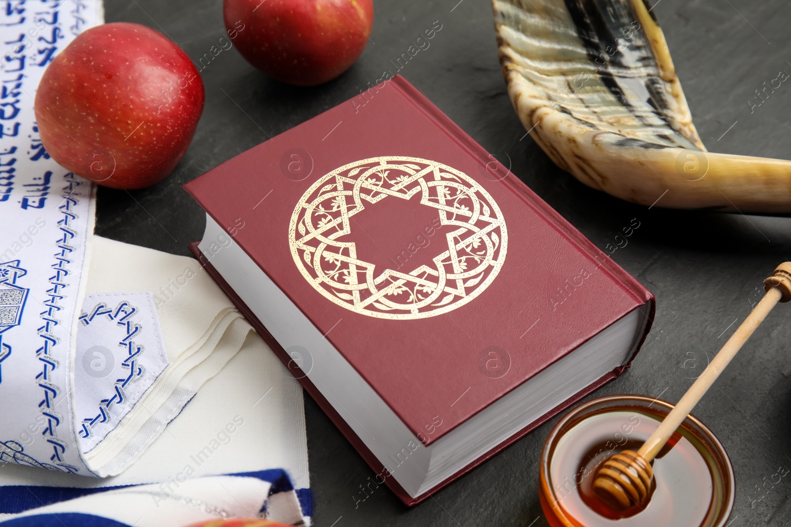 Photo of Composition with Rosh Hashanah holiday symbols on black table