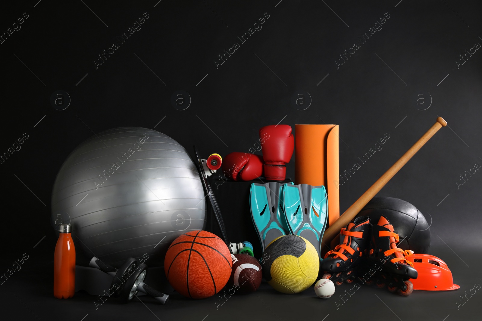 Photo of Set of different sports equipment on black background