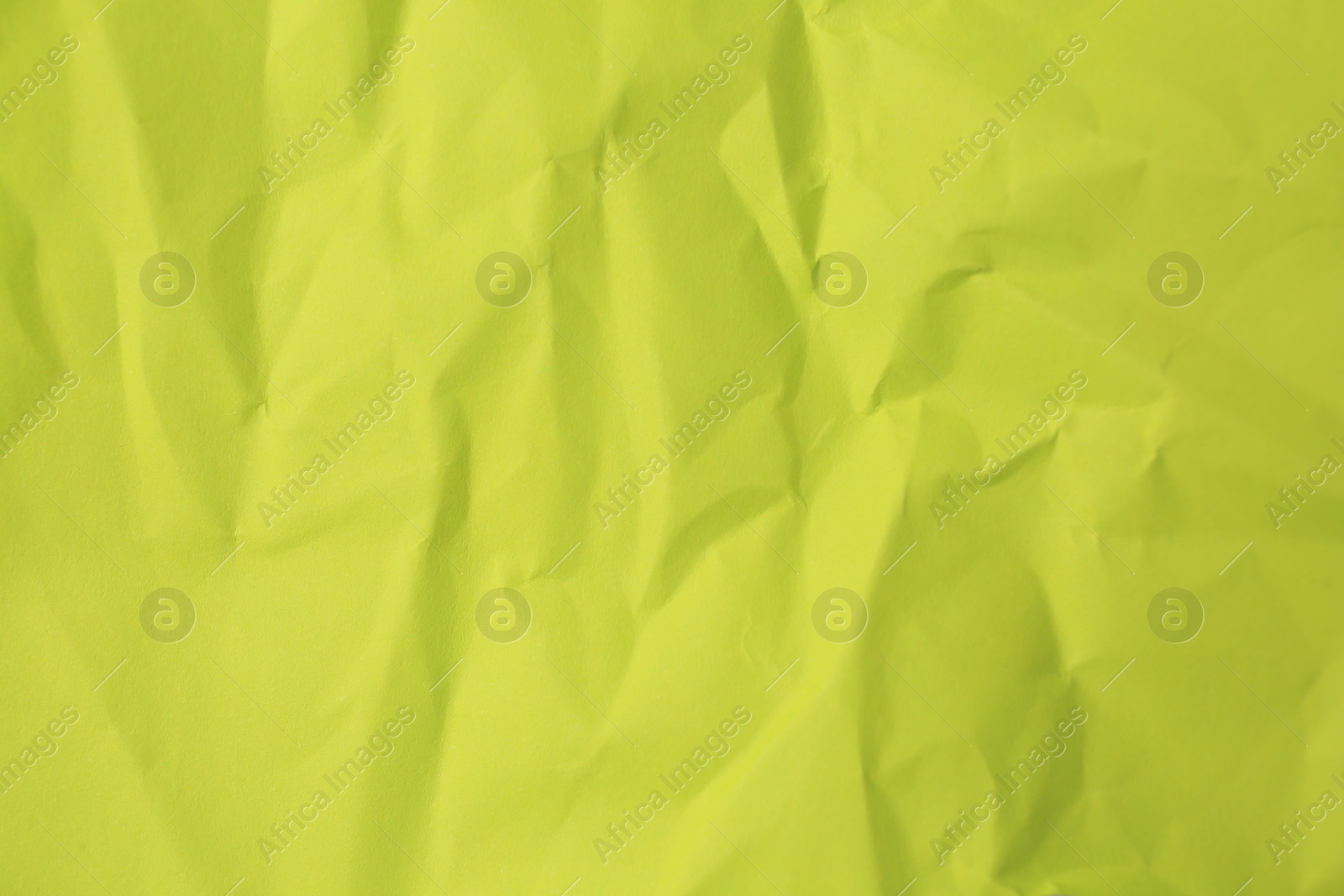 Photo of Sheet of crumpled light green paper as background, top view