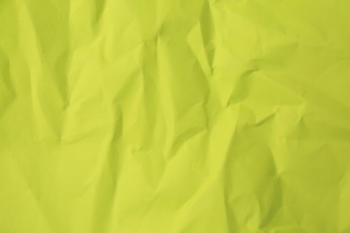Photo of Sheet of crumpled light green paper as background, top view