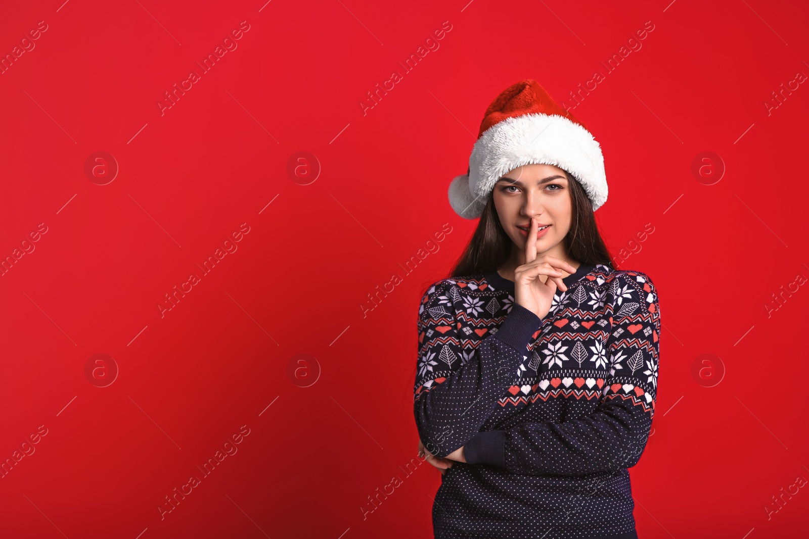 Photo of Young beautiful woman in Santa hat on color background. Christmas celebration