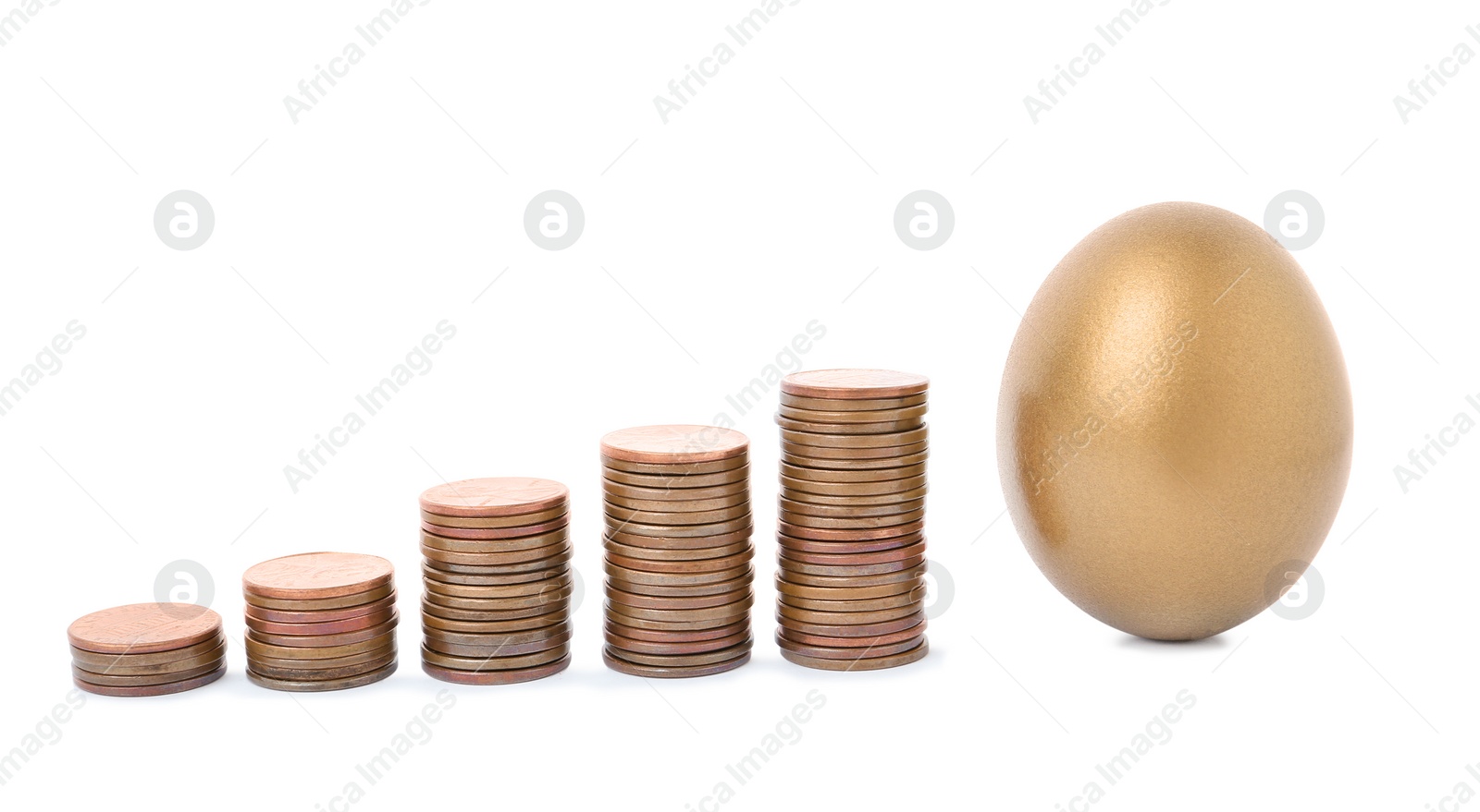 Photo of Gold egg and stacks of coins on white background