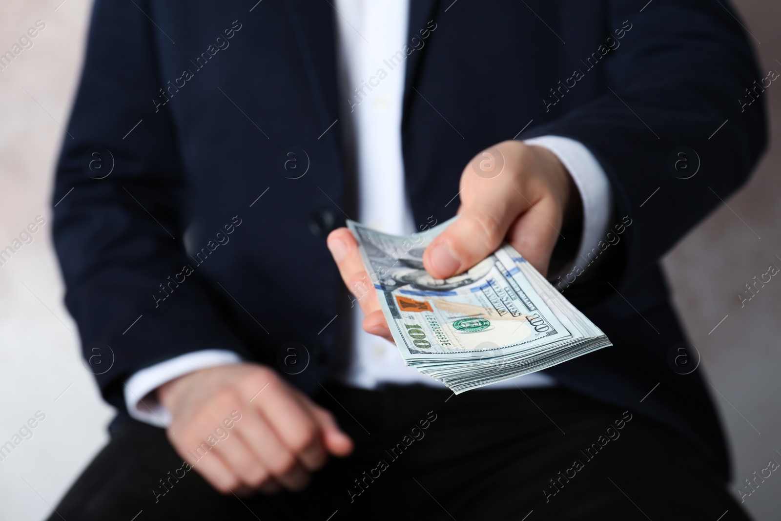 Photo of Closeup view of man in suit offering money indoors