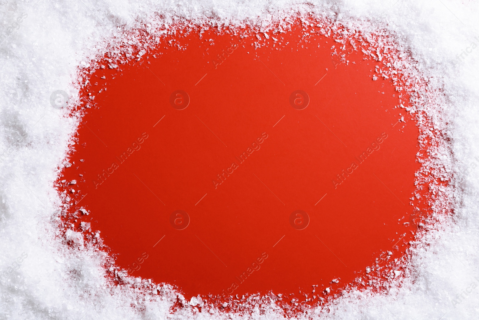 Photo of Frame made with snow on color background, top view with space for text