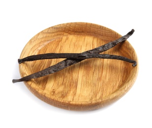 Photo of Wooden plate with aromatic vanilla sticks on white background