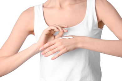 Photo of Young woman applying hand cream on white background, closeup