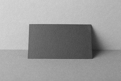 Photo of Blank black business card on grey background. Mockup for design