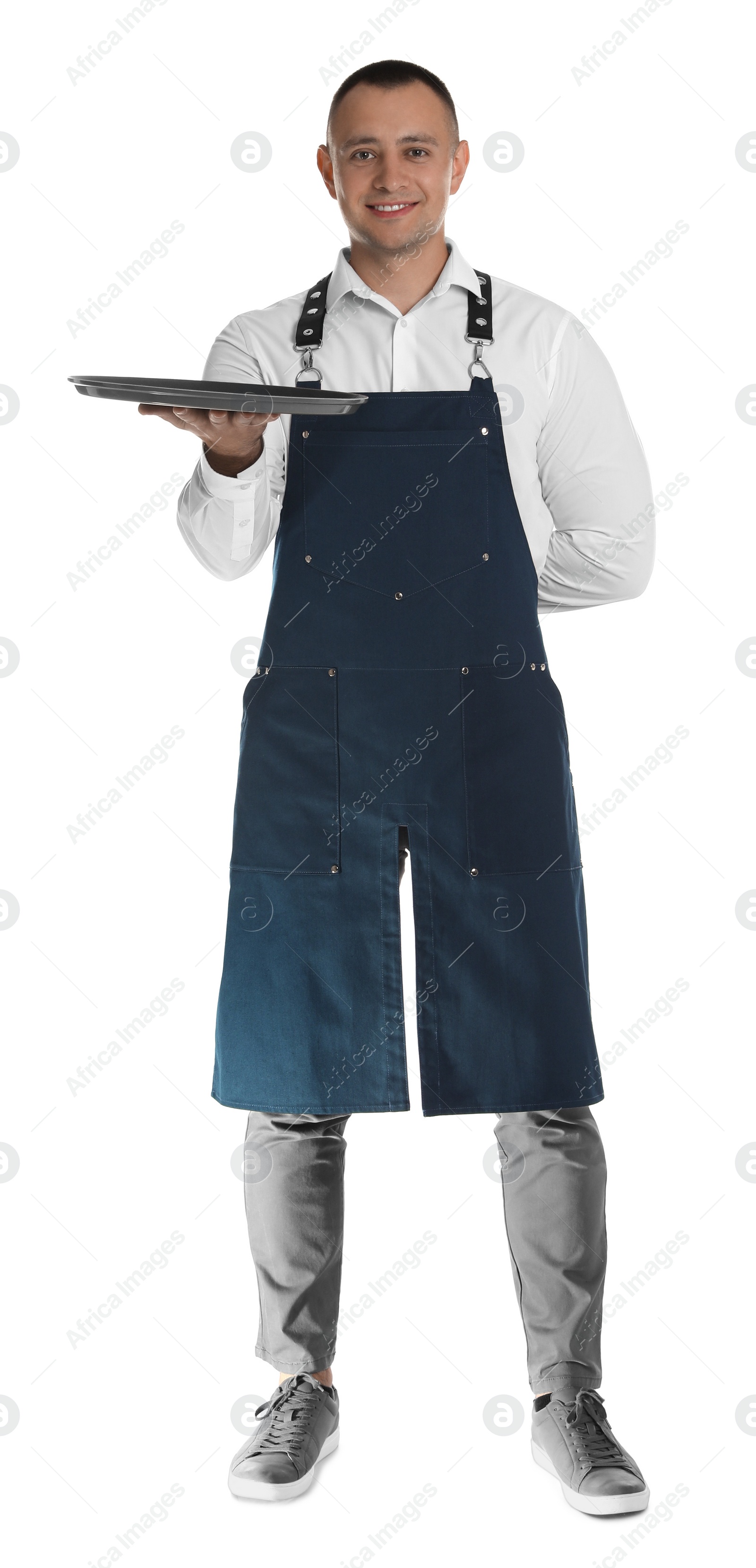 Photo of Full length portrait of happy young waiter with tray on white background