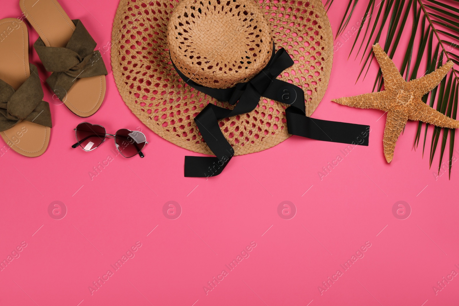 Photo of Flat lay composition with beach objects on pink background, space for text