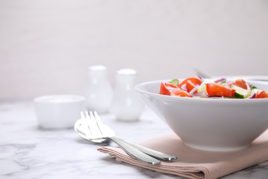 Delicious fresh cucumber tomato salad served on table, space for text