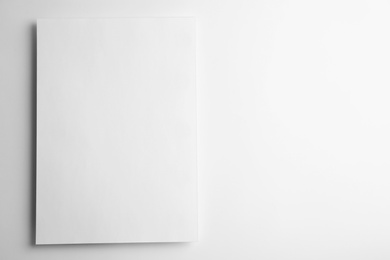 Photo of Blank paper sheet on white background, top view. Mock up for design