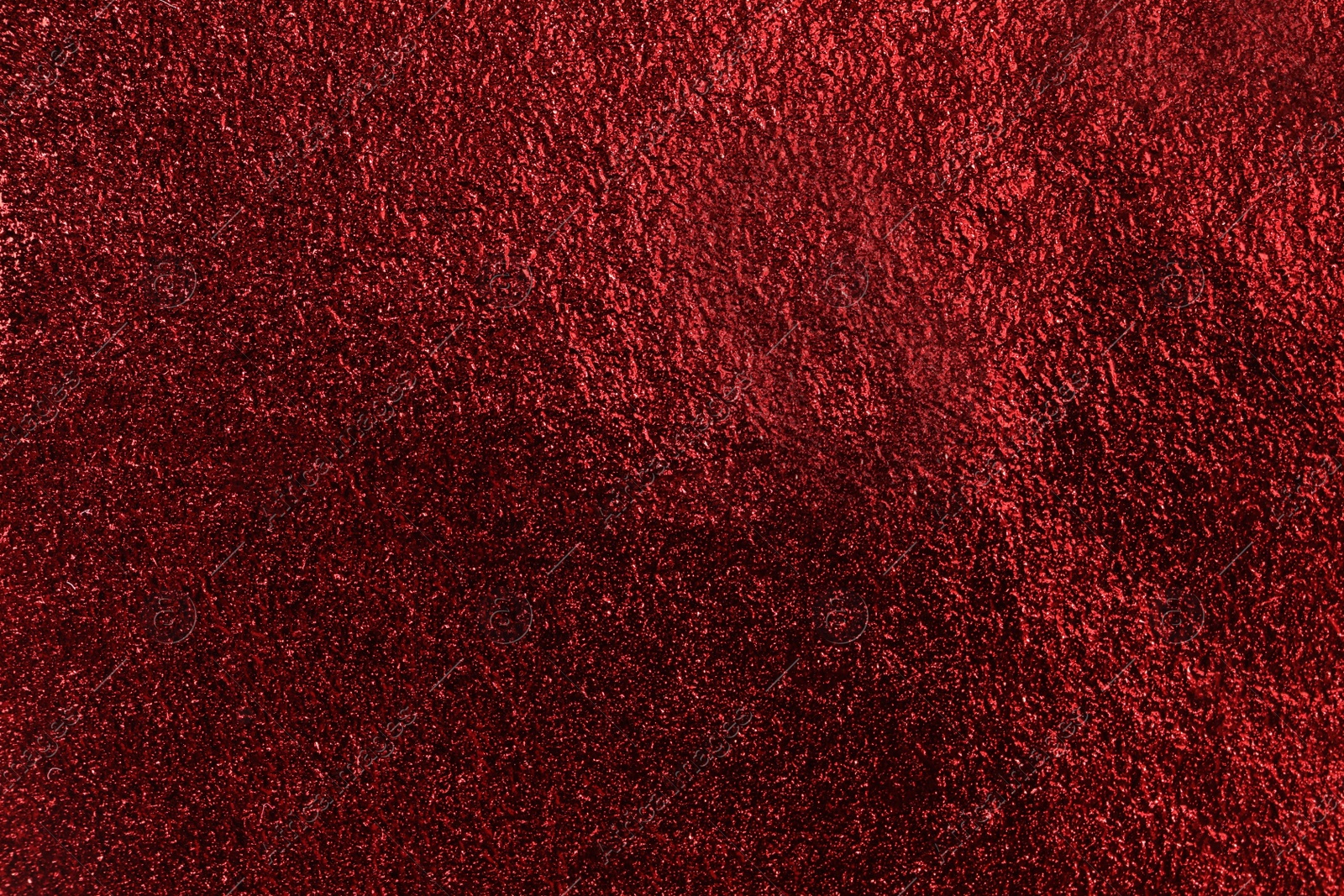 Photo of Textured red foil as background, top view