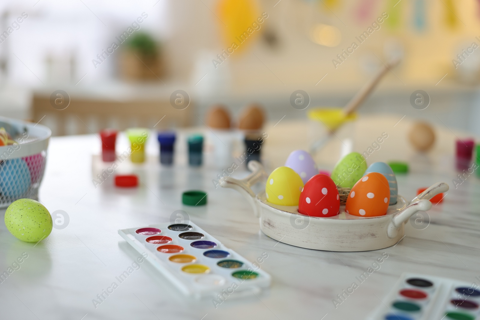 Photo of Happy Easter. Painted eggs and watercolor on white marble table indoors