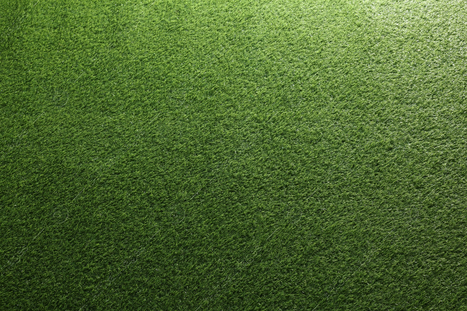 Photo of Green artificial grass as background, top view