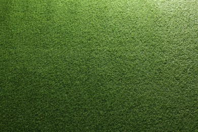 Photo of Green artificial grass as background, top view