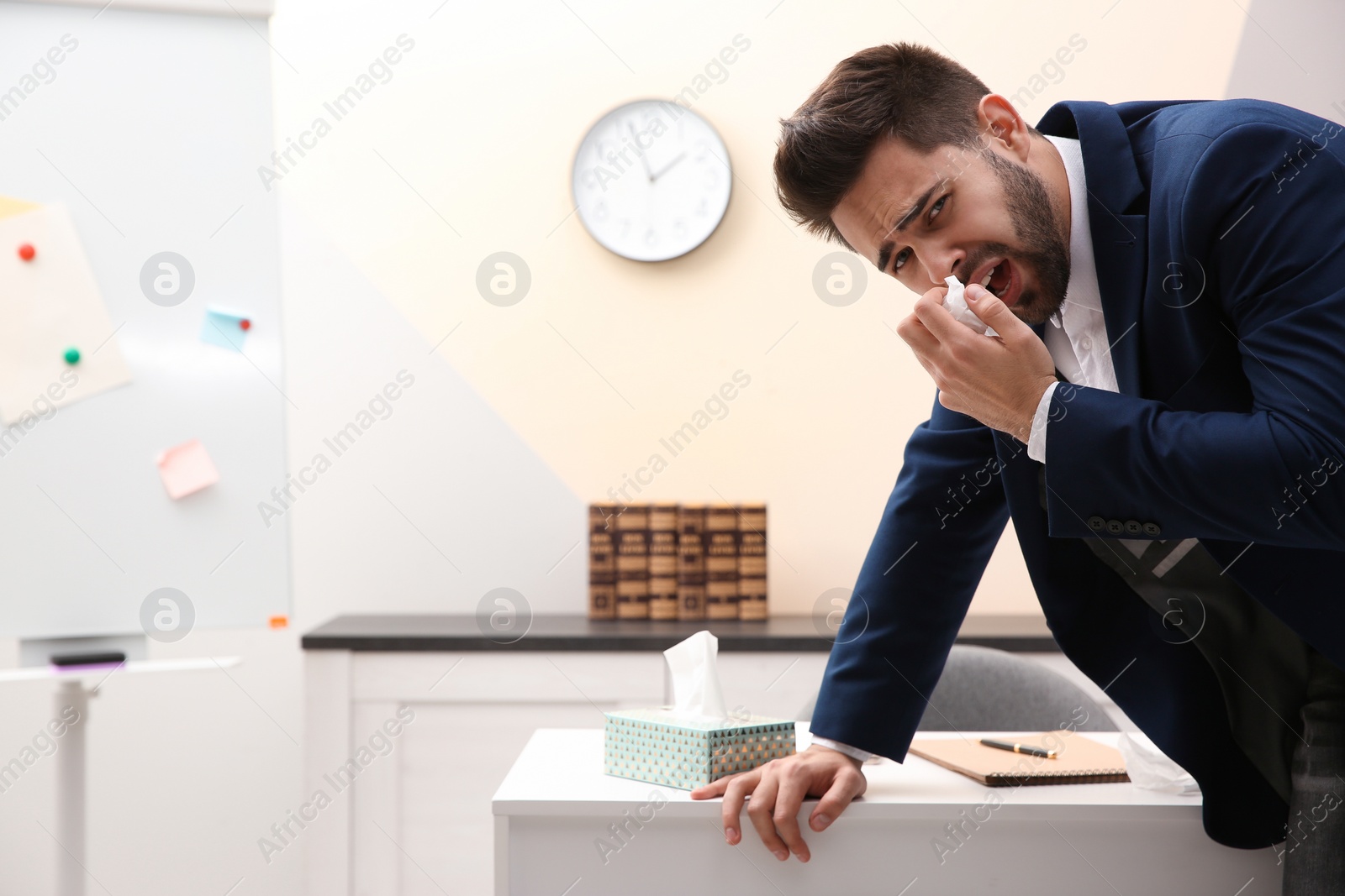 Photo of Sick young man at workplace. Influenza virus