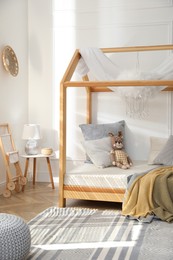 Stylish child room interior with house bed