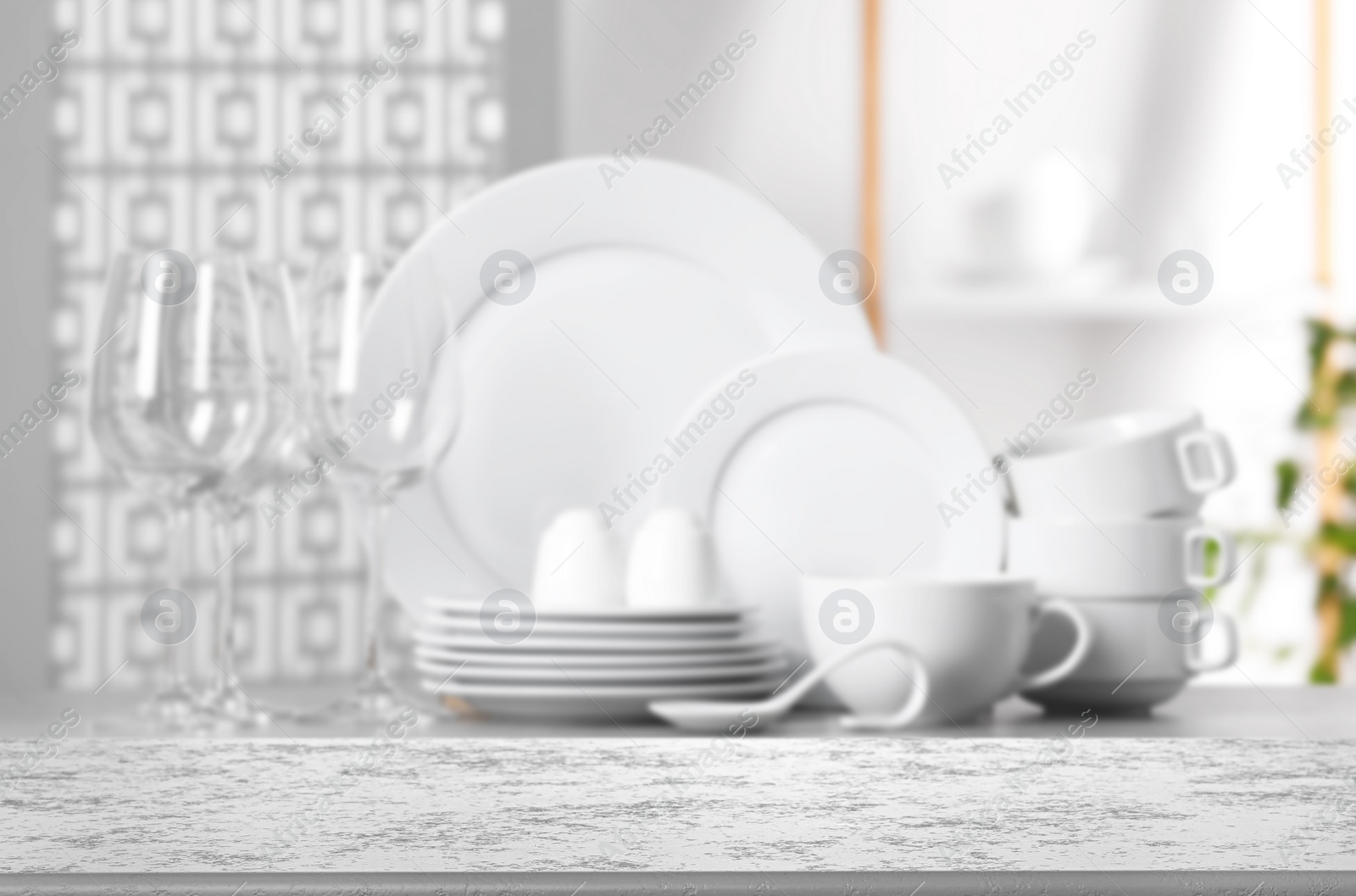 Image of Set of clean dishware, focus on empty stone table