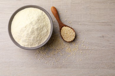 Photo of Ceramic bowl with quinoa flour and seeds on wooden table, flat lay. Space for text