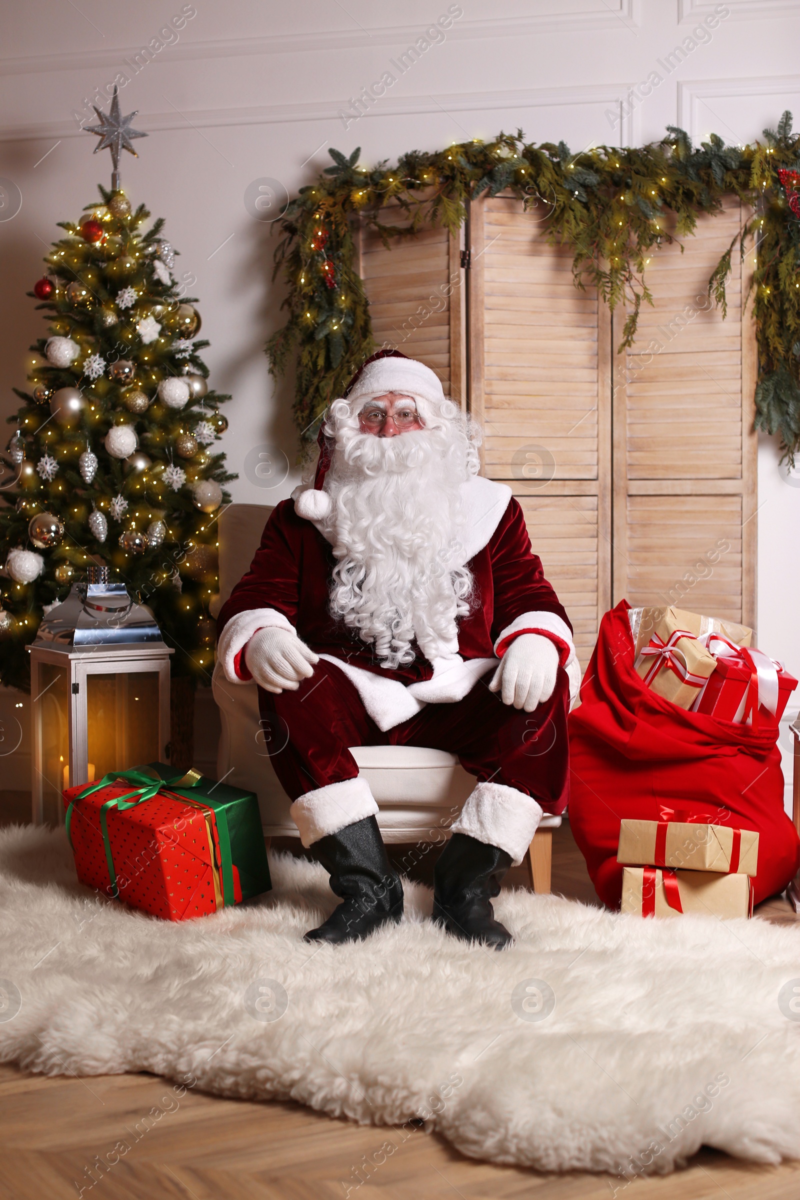 Photo of Santa Claus in photo zone decorated for Christmas