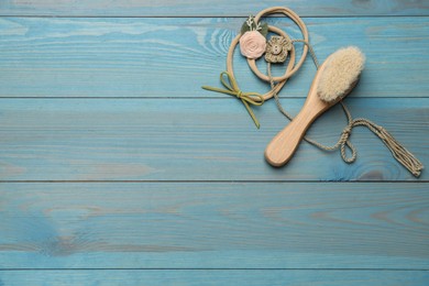 Photo of Baby accessories on light blue wooden background, flat lay. Space for text