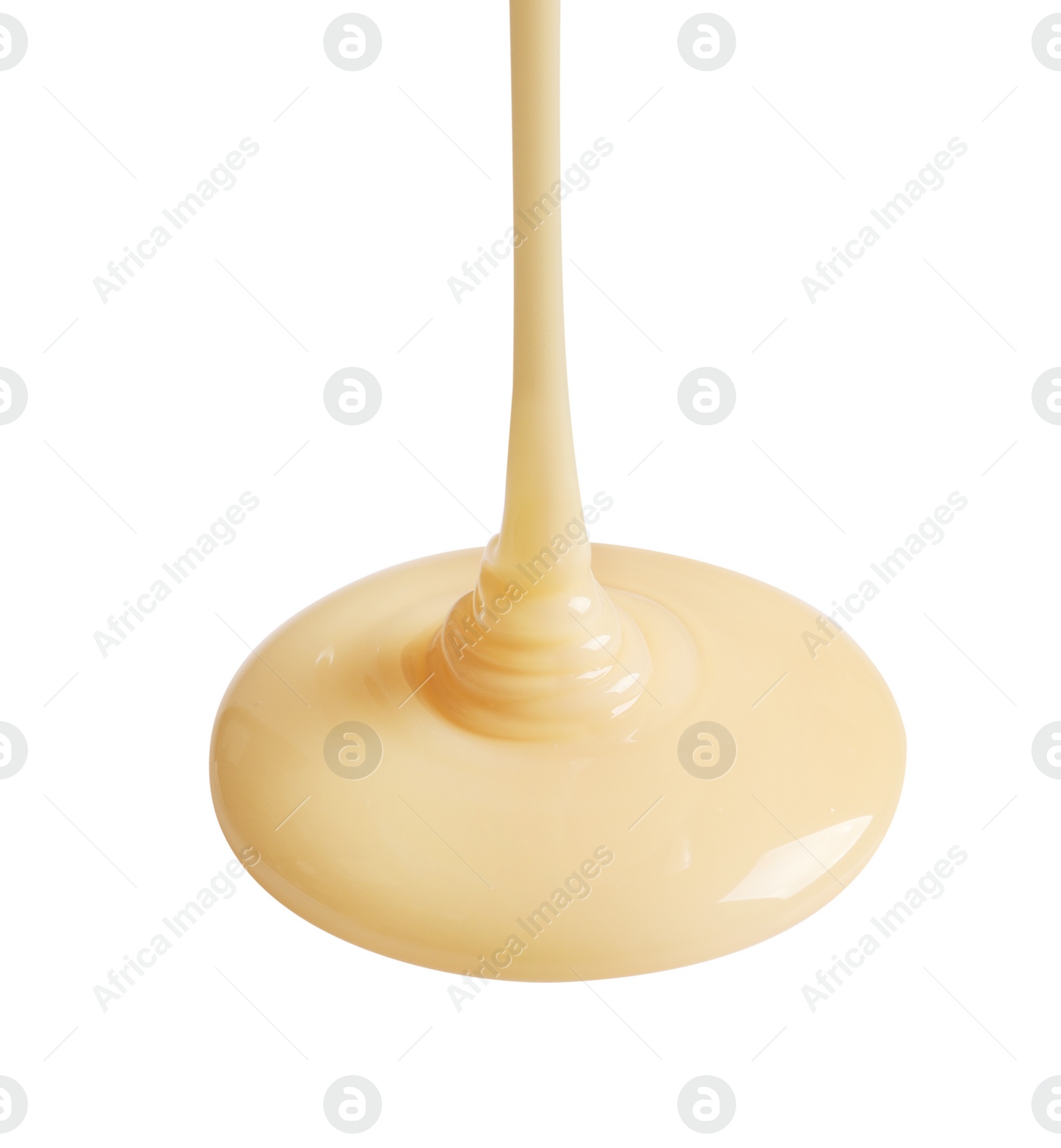 Photo of Tasty pouring condensed milk on white background. Dairy product