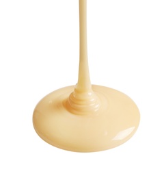 Photo of Tasty pouring condensed milk on white background. Dairy product