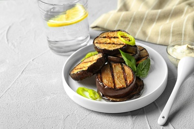 Photo of Plate with fried eggplant slices on table