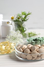 Photo of Different pills on white wooden table. Dietary supplements