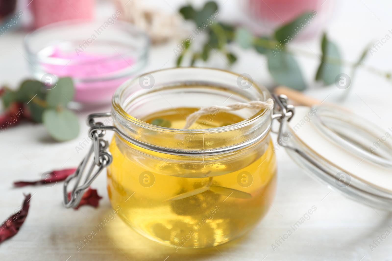 Photo of Aromatic homemade candle in glass jar on light table