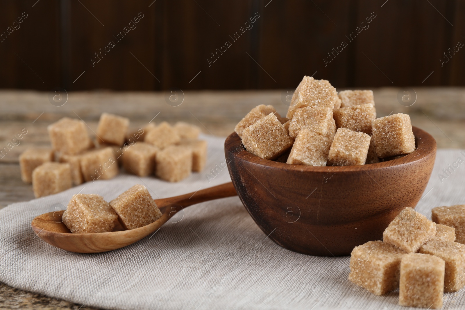 Photo of Many brown sugar cubes on table, closeup