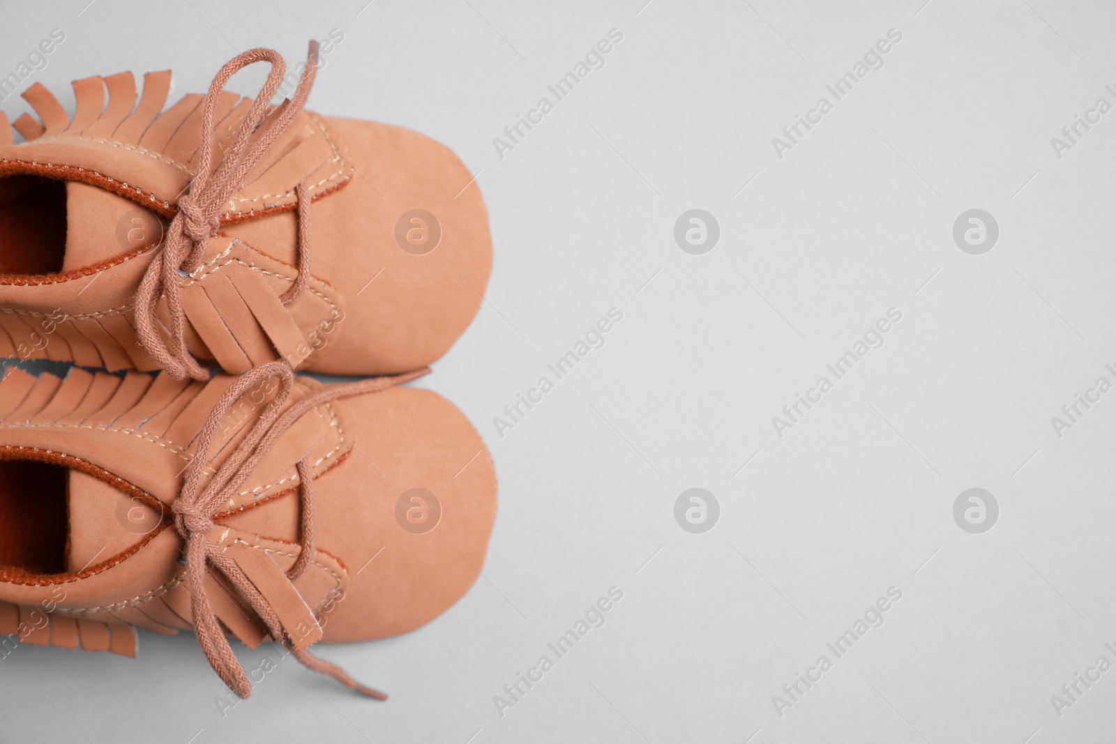 Photo of Cute baby shoes on grey background, flat lay. Space for text
